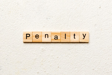 PENALTY word written on wood block. PENALTY text on cement table for your desing, concept