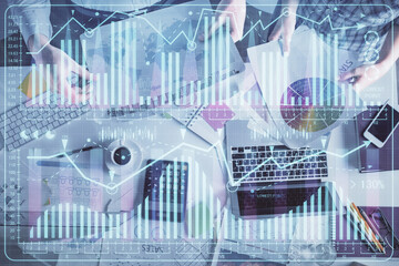 Double exposure of man and woman working together and financial chart hologram drawing. market analysis concept. Computer background. Top View.