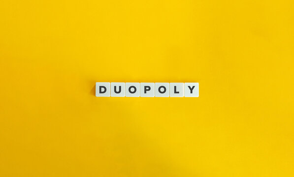 Duopoly Word on Block Letter Tiles on Yellow Background. Minimal Aesthetics.