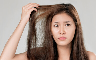 Ardent young girl feels insecure about her damaged hair. Beauty concept of brittle hair and how to...