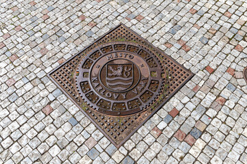 Karlovy Vary, Czech Republic - August 6, 2022, Karlovy Vary sign on an iron manhole cover in the city center.