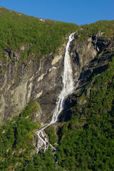 Fototapeta na wymiar Geiranger Fjord in Norway with waterfalls cascading down the high mountains.
