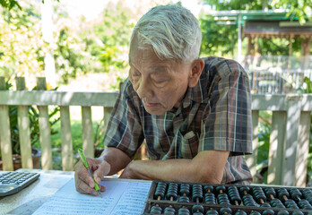 Old Chinese man using classic abacus