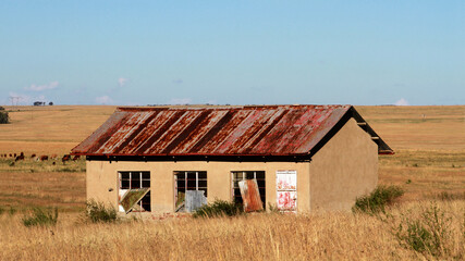 Photo of abandoned old houses and buildings in South Africa, red stone, mud and stone walls