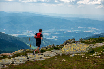 A young athlete enjoys running on the crest of the Chopok mountain in the Low Tatras in Slovakia