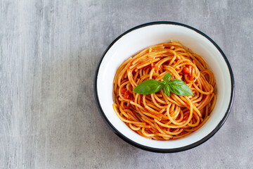 Tomato spaghetti on grey background, directly above