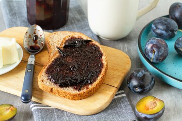 Breakfast with plum jam, bread and butter