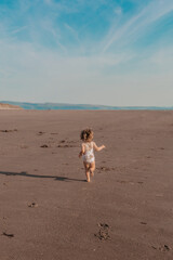 child playing on the beach