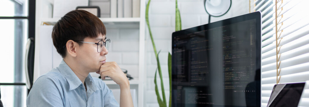 Professional development programmers are laying out a structure or draft on paper in preparation for coding on a computer, Write information or code for the website,  HTML, javascript, Software.