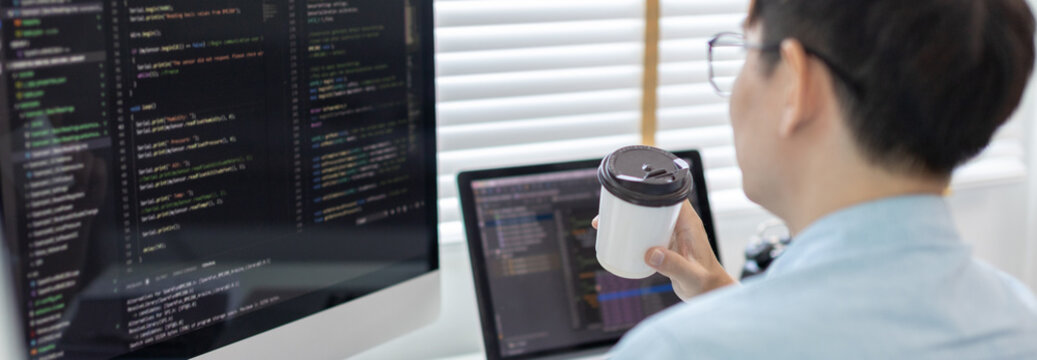 Professional development programmers are sipping coffee in a private office, Working on coding or programming on a computer, Write information or code for the website,  HTML, Javascript, Software.