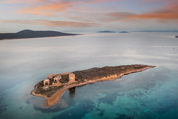 Cunda Paterica bay pigeon island ruins of an old hospital building and beautiful blue sea aerial...
