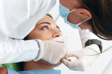 Young woman visits the dentist and has a routine examination. Person with dental separator