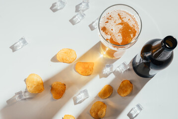 cold glass beer with chips and ice