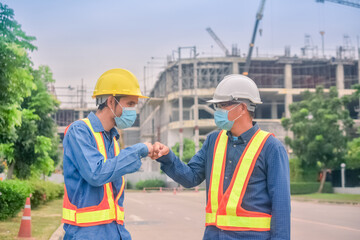 Asian team Construction engineers supervising progress of construction project stand on new factory, Engineering Consulting People on construction site Building inspector.