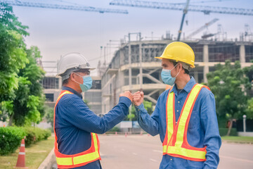 Asian team Construction engineers supervising progress of construction project stand on new factory, Engineering Consulting People on construction site Building inspector.