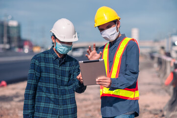 Asian Engineer construction are worker employee working by safety control helmet on site building
