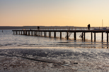 Fototapeta premium High quality photo of a pier at sundown. Wooded bridge seaside with Sunset, Strunjan. Slovenia