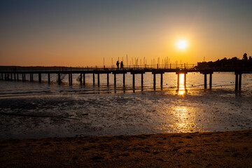 Fototapeta na wymiar High quality photo of a pier at sundown. Wooded bridge seaside with Sunset, Strunjan. Slovenia