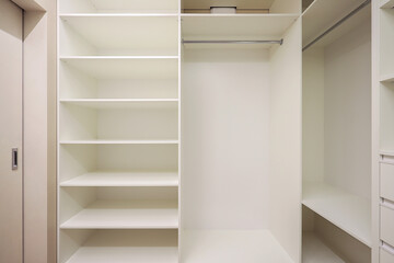 White wardrobe with shelves in the dressing room