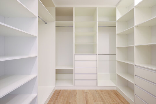 White wardrobe with shelves in the dressing room