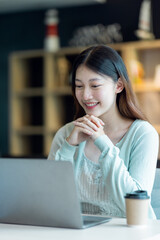 Young Business Asian woman sitting at a desk with a laptop and working in the home office or her workplace, accountant tax contract report analysis document data Audit concept.