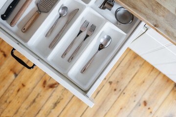 open cutlery box with silverware at kitchen