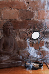 Fototapeta premium home decoration with buddha figurine and aroma sticks, meditation concept