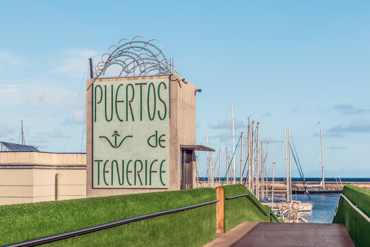 Santa Cruz de Tenerife, Spain - November 24, 2021: Sign with text Puertos de Tenerife on the coast of the Atlantic Ocean in Santa Cruz de Tenerife. Signboard of the Port of Santa Cruz de Tenerife