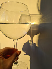 Wineglass in hand, sunset. Aesthetics