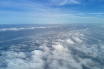 Fototapeta na wymiar Aerial view from high altitude of earth covered with puffy rainy clouds forming before rainstorm