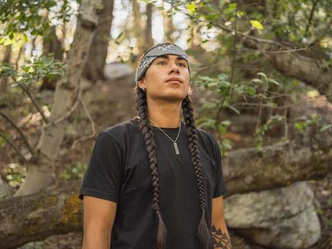 Indigenous young man hiking in nature