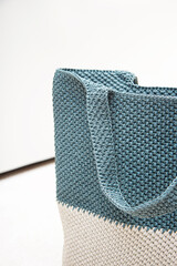 Blue knitted bag handmade outdoors. Sustainable shopping. Waste-free lifestyle. Do-it-yourself jute bag