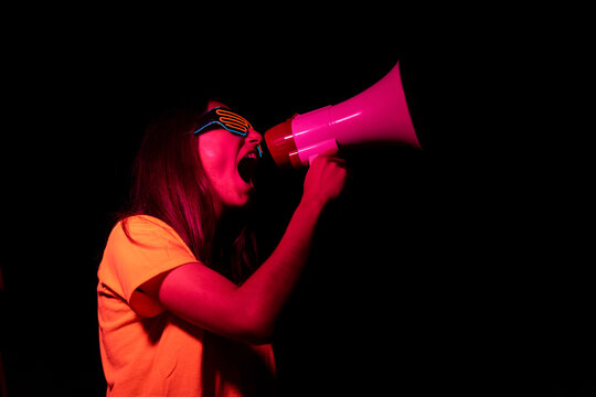 Young woman screaming in loudspeaker