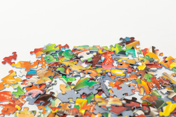 Isolated pile of colourful puzzle pieces 