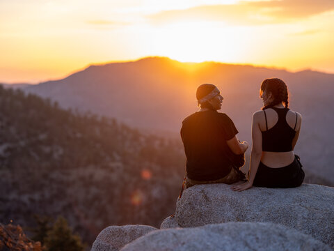 Young native people in hiking gear during sunset 
