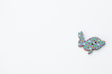 Wooden figures in the form of rabbits on a white background. Easter concept
