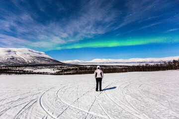 Aurora borealis at Abisko in Sweden. a night with colors in the sky. cold, snow and lights a...