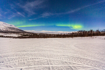 Aurora borealis at Abisko in Sweden. a night with colors in the sky. cold, snow and lights a beautiful landscape