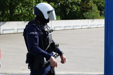 Policjant oddziału prewencji na zabezpieczeniu imprezy sportowej. Tarcza policyjna.  - obrazy, fototapety, plakaty