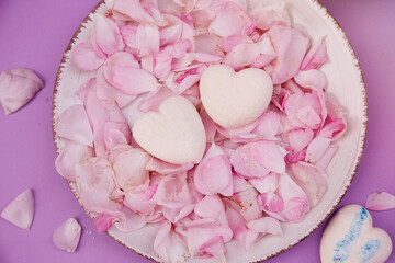 Homemade natural sugar free vanilla marshmallows hearts on rose petals. Healthy sweets, natural food. Romantic background