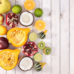 Creative arrangement of healthy autumn  fruits on cuting board on wooden background. Flat lay