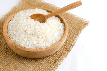 Dry camolino rice in a wooden bowl with a wooden spoon. The concept of healthy eating. Rustic style. Selective focus. Horizontal orientation.