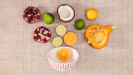  Creative summer background with slicedfruits in bowl on beige theme. Flat lay