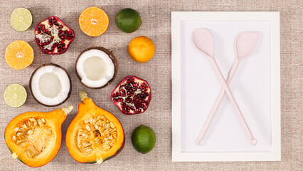 Autumn sliced fruits on beige background with copy space frame. Flat lay