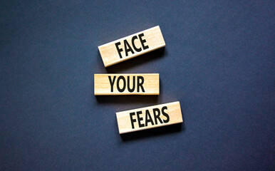 Face your fears and support symbol. Concept words Face your fears on wooden blocks. Beautiful black...