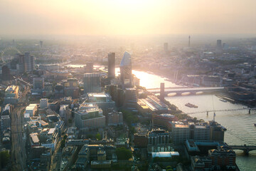 Sunrise in London. City of London view at early morning and beautiful sun reflection in Thames river. UK