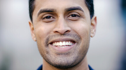 Portrait of handsome Indian male looking to camera and smiling