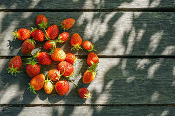 red strawberries on an old vintage wooden base