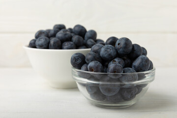Blueberries in a bowl on white textured background. Ripe and fresh blueberries. Vitamins. Healthy food. Juicy berry.Copy space.Place for text