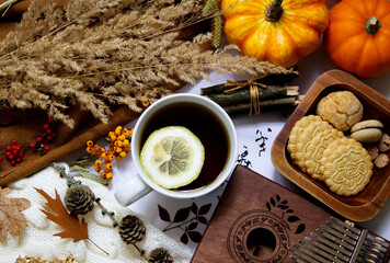 A cup of tea on a table decorated with autumn decor